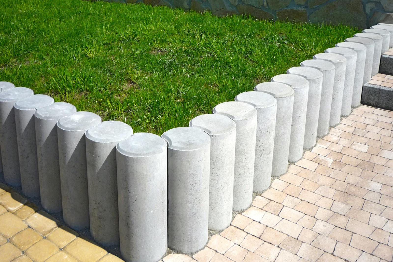 Power-edged border between concrete walk and lawn, showing a deliberate cut line.